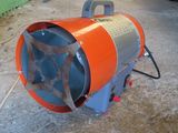 an orange and blue blower sitting on the ground