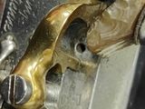 a close up of a gun with a metal handle