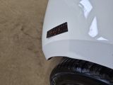 a sticker on the hood of a white car