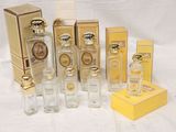 a lot of perfume bottles and boxes on a table