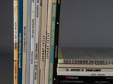 several books stacked on top of each other on a table