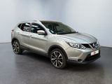 the silver nissan suv is parked in a large room