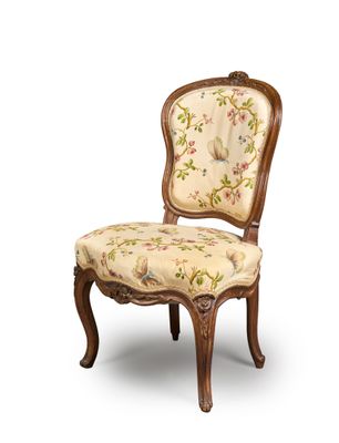 an image of a chair with a floral upholstered seat and back
