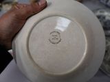 a person holding a white plate with a black writing on it