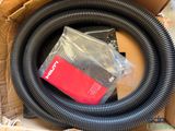 a black hose in a cardboard box with a red box