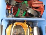 a blue container with a yellow and black helmet and other items in it