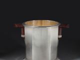 an antique silverplated ice bucket with wooden handles