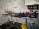 a kitchen with a sink and a counter with dishes on it