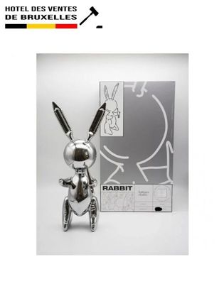 the silver rabbit is standing next to the box of the silver rabbit