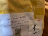 a bag of mail sitting on a bed with a sticker on it