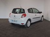 a picture of a small white car parked in a garage
