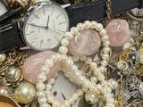 a pile of assorted jewelry on a table