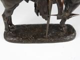 bronze statue of a man on a horse with a sword