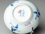 a white bowl with blue and orange designs on it