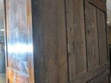 an old wooden cabinet in a room with tile flooring