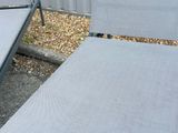 two lawn chairs that are sitting in the gravel