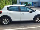 a picture of a white car parked in a parking lot
