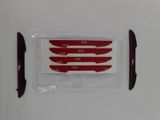 four knives in a plastic bag on a white surface