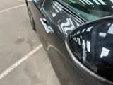 a black car parked in a parking lot next to a parking meter