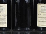 six bottles of wine are lined up on a table
