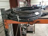 an image of a garage with a bunch of hoses on a shelf