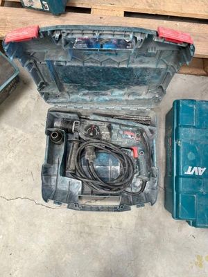 a blue tool box with tools in it sitting on the floor
