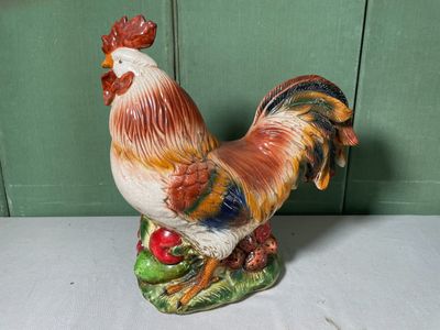 a figurine of a rooster sitting on a table