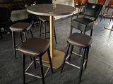 a table with four stools and a vase on top of it