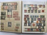 an open book with stamps on it on a table