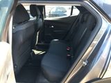 the back seat of a car with a black seat cover