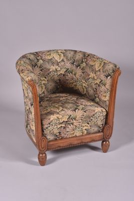 a chair with a floral upholstered back and a wooden frame