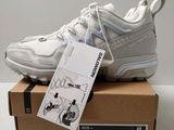 a close up of a pair of white sneakers on a box