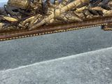 a gold colored bench with a bunch of birds on it