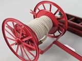 a red fire engine with a rope attached to it