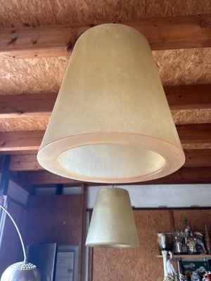 two lamps that are hanging from the ceiling in the room