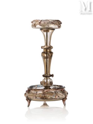 an antique silver plated candle holder with a flower design on it