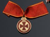 an image of a medal with a red ribbon on a black background