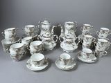 a lot of cups and saucers that are sitting on a table