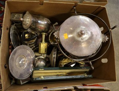 a cardboard box full of silver items on the floor