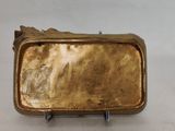 an image of a gold plate with a bird on top of it