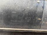 a dirty car that is parked on the side of the road