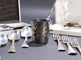a bunch of spoons and forks sitting on a table