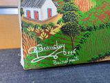 a painting of a house on the back of a suitcase