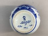 a blue and white vase with writing on it