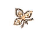 a close up of a brooch with a flower on it