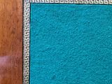 a blue area rug on the floor of a room