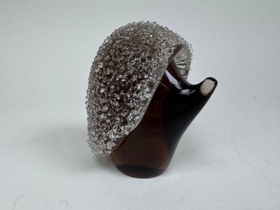 a brown vase with a silver cap on top of it