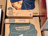 many boxes of pizza sitting on the floor next to each other
