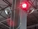 a red light that is on a pole in a building