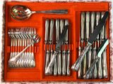 a tray with silverware in it and a spoon in it